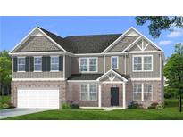 Charming two-story home with a brick facade, well-manicured lawn and integrated two-car garage at 612 Sidney Ct, Stockbridge, GA 30281