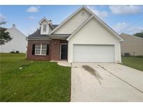 Charming home with a well-maintained lawn and a two-car garage at 5480 Walnut Ln, Lithonia, GA 30038