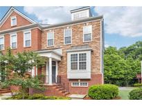 Beautiful two-story townhome featuring brick and stone accents with manicured landscaping at 2252 Limehurst Ne Dr, Atlanta, GA 30319