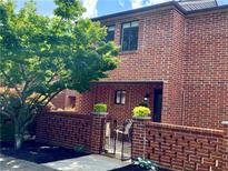 Charming two-story brick home with landscaped yard and gated entrance at 2259 Pernoshal Ct, Dunwoody, GA 30338