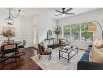 Bright living room with hardwood floors, modern furnishings, and lots of natural light at 2700 Pine Tree Ne Rd # 1208, Atlanta, GA 30324