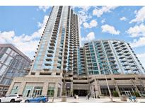 Modern high-rise condo building with balconies and street-level shops, parking garage and beautiful landscaping at 400 W Peachtree Nw St # 3611, Atlanta, GA 30308