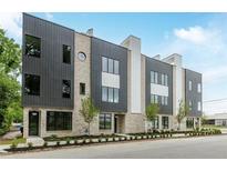 Modern townhome showcasing gray and white panels, light brick, well-maintained landscaping, and large windows at 1962 8Th St, Chamblee, GA 30341