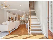 Open concept living room with hardwood floors flows into the kitchen with an island and stainless steel appliances at 1199 Huff Nw Rd # 127, Atlanta, GA 30318