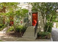 Charming townhouse with red front door and well-maintained landscaping with stairs and iron railing at 461 Bartram Se St # A, Atlanta, GA 30316