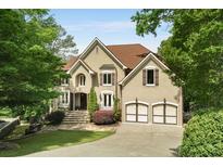 Stunning two-story home with a well-manicured lawn and attached two-car garage at 95 Grogans Lndg, Atlanta, GA 30350
