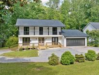 Charming two-story home with a gray roof, white siding and a well-maintained front yard at 4205 Mabry Ne Rd, Roswell, GA 30075