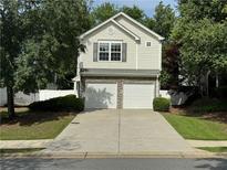 Charming two-story home featuring a two-car garage and well-maintained landscaping at 143 Ilex Dr, Canton, GA 30114