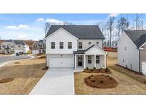 Charming two-story home with white brick and a two-car garage in a well-manicured neighborhood at 1851 Lacebark Elm Way, Lawrenceville, GA 30045