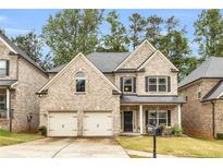 Charming two-story home with a two-car garage and manicured front lawn at 891 Channel Dr, Lawrenceville, GA 30046