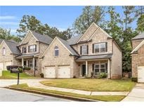 Charming brick home with a well-manicured lawn and a two-car garage in a tree-lined neighborhood at 891 Channel Dr, Lawrenceville, GA 30046