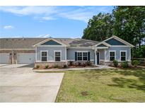 Charming single-story home featuring a well-manicured lawn and an attached two-car garage at 3919 Shelleydale Dr, Powder Springs, GA 30127