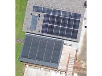 Aerial view of a home featuring multiple solar panels on the roof and over the patio at 3112 Calumet Nw Cir, Kennesaw, GA 30152