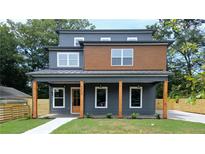 Charming new construction home featuring a covered porch with striking wood columns and a combination of grey and wood siding at 1197 Avondale Se Ave, Atlanta, GA 30312