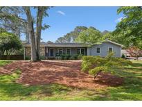 Charming single-story home with a well-maintained lawn, mature trees, and welcoming front porch at 1280 Sherry Dr, Alpharetta, GA 30009