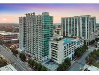 Luxury high-rise condominiums with an outdoor rooftop pool overlooking the city skyline at sunset at 250 Pharr Ne Rd # 1112, Atlanta, GA 30305