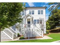 Charming two-story townhome with a welcoming front porch and well-maintained landscaping at 1405 Attwater Dr, Atlanta, GA 30316
