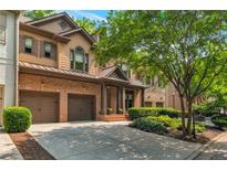 Charming two-story home with brick and siding exterior, attached two-car garage, and professionally landscaped front yard at 2664 Long Pointe, Johns Creek, GA 30076
