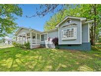 Charming single-story home boasts a inviting front porch and manicured lawn at 3428 Quail Sw Run, Marietta, GA 30008