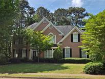 Traditional two-story brick home with black shutters and a well-manicured front lawn at 1000 Admiral Xing, Alpharetta, GA 30005
