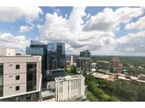 Expansive city view showcasing modern architecture and lush greenery under a cloudy sky at 1280 W Peachtree Nw St # 3602, Atlanta, GA 30309