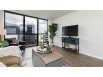 Bright living room with expansive city views and modern furnishings at 1280 W Peachtree Nw St # 3602, Atlanta, GA 30309