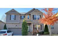 Charming two-story brick home with a well-manicured front yard and attached two-car garage at 4520 Essen Lane, Cumming, GA 30041