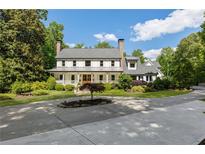 Stunning two-story home boasting a beautiful front porch and well-manicured landscaping at 11355 Bowen Rd, Roswell, GA 30075