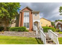 Charming multi-level home featuring a mix of brick and siding with stone retaining wall and landscaped lawn at 1731 Pryor Sw Rd # 109, Atlanta, GA 30315