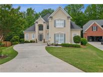 Stunning two-story home with a long driveway, manicured lawn, and charming architectural details at 4735 Cambridge Trce, Atlanta, GA 30338