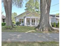 Charming home with a welcoming front porch framed by mature trees and a well-manicured lawn at 78 Atlanta Se Ave, Atlanta, GA 30315