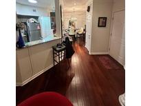 Inviting foyer boasts gleaming hardwood floors and seamless flow into the dining area at 200 Renaissance Ne Pkwy # 305, Atlanta, GA 30308