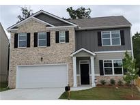 Charming two-story home with a brick facade, complemented by black shutters and a well-manicured front lawn at 3650 River Rock Rd, Lithonia, GA 30038