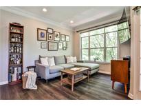 Inviting living room with a plush gray sectional, natural light, and stylish decor at 955 Juniper Ne St # 4332, Atlanta, GA 30309