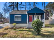 Charming blue two-story home features a red front door and a well-maintained front yard at 2584 Oldknow Dr, Atlanta, GA 30318