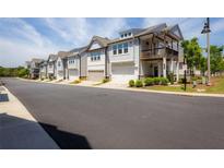 Row of new townhomes featuring attached garages in a well-maintained community at 360 Hayden Cir, Woodstock, GA 30189