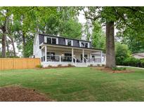 Charming two-story home with a welcoming front porch and a lush green lawn at 550 Stewart Nw Ave, Marietta, GA 30064