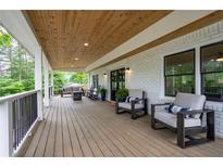 Spacious porch with seating, wood ceiling, white brick and black trim, perfect for outdoor relaxation at 550 Stewart Nw Ave, Marietta, GA 30064