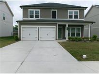 Charming two-story home with a two-car garage and a well-maintained front yard at 2197 Boxwood Cir, Conyers, GA 30094