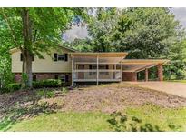Charming home featuring a covered porch and a convenient carport at 4016 Nations Dr, Douglasville, GA 30135