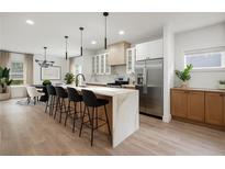 Bright kitchen features a large island with seating, stainless steel appliances, and modern pendant lighting at 32 Wadley Nw St, Atlanta, GA 30314