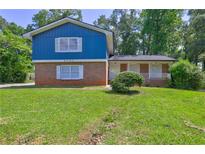 Charming two-story home with brick accents and lush green lawn at 4593 Bexley Way, Stone Mountain, GA 30083