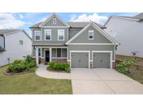Charming two-story home with a well-manicured lawn and a two-car garage at 2431 Kingston Heath Way, Marietta, GA 30008