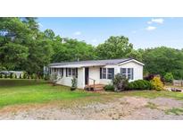 Charming single-story home with green lawn, lush landscaping, and classic black shutters at 901 N Van Wert Rd, Villa Rica, GA 30180