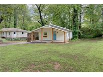 Charming single-story home with a covered porch and well-maintained lawn surrounded by mature trees at 2917 Reveille Se Cir, Atlanta, GA 30316