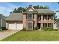 Charming two-story brick home with a well-manicured lawn and a two-car garage at 3570 Steve Nw Dr, Marietta, GA 30064