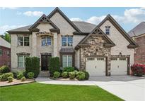 Beautiful two-story brick home with a well-manicured lawn and a two-car garage at 5068 Bentwater Sw Ln, Lilburn, GA 30047