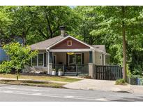 Charming home with a welcoming front porch, lush landscaping, and a well-maintained yard at 770 Ormewood Se Ave, Atlanta, GA 30312
