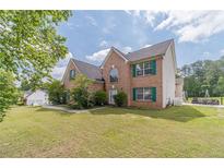 Charming brick home with a well-manicured lawn and inviting curb appeal at 4023 Port Springs Trl, Snellville, GA 30039