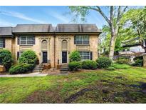 Charming brick townhouse with well-manicured lawn and garden entryway at 6980 Roswell Road # A8, Atlanta, GA 30328